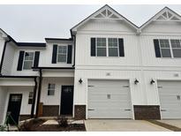 Charming two-story home with white siding, black shutters, and attached garage at 132 S Mistflower St, Clayton, NC 27520