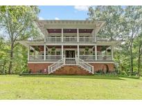 Two-story home with wrap-around porch and brick accents at 415 River Bluff Dr, Dunn, NC 28334