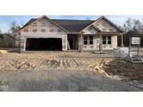 Newly constructed one-story home with attached garage and sandy front yard at 700 Tuscany Cir, Princeton, NC 27569