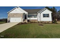 Modern farmhouse exterior with stone and white siding at 11340 International Dr, Middlesex, NC 27557