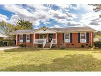 Brick ranch house with a spacious yard and a welcoming front porch at 1717 Martin Luther King Dr, Rocky Mount, NC 27801