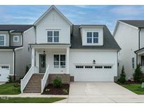 Two-story white house with gray accents and a two-car garage at 1733 Grassy Falls Ln, Wendell, NC 27591