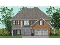 Brick two-story home with a two-car garage and shutters at 216 Augusta Pond Way # 127, Raleigh, NC 27603