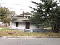 White house with front porch needs renovation at 313 E Umstead St, Durham, NC 27707