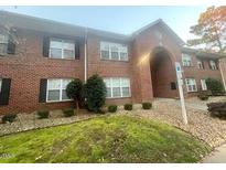 Brick building with multiple units, landscaped grounds, and ample parking at 1513 Kenmore Dr # 1513, Clayton, NC 27520