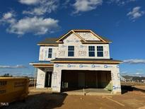 Two-story house with gray siding, dark roof, and a two-car garage at 1073 Channel Drop Lp, Zebulon, NC 27597