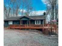 Ranch home with large deck, landscaped yard, and spacious driveway at 3641 Durham St, Burlington, NC 27217