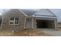 Newly constructed brick home with a two-car garage and landscaping at 55 Sawtooth Oak Ln, Youngsville, NC 27596