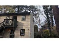 Exterior view of a light beige building with green accents at 311 Ashley Forest Rd # Bldg E, Chapel Hill, NC 27514