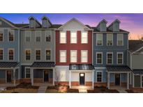 Three-story townhouses with brick and siding exteriors, showcasing a modern design at 121 Pearl St # 4, Garner, NC 27529