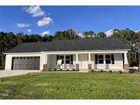 New construction home with a grey roof and a stone accent at 131 Tulipfield Way, Benson, NC 27504