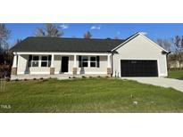 New construction home with gray siding, black garage door, and a front porch at 396 Magnolia Run Way, Benson, NC 27504
