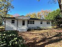 White Ranch style home with mature landscaping and large yard at 445 N Dunn St, Angier, NC 27501