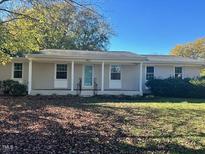 Charming ranch home with a covered porch and well-maintained lawn at 465 N Dunn St, Angier, NC 27501