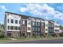 New townhome community with three-story homes, featuring brick and siding exteriors and balconies at 1508 Village Hall Ln, Wake Forest, NC 27587