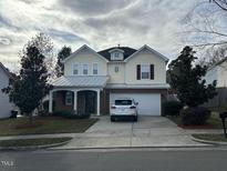 Two-story house with brick and siding, attached garage, and landscaping at 305 Pebblestone Dr, Durham, NC 27703