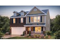 Two-story house with brick and siding, a two-car garage, and landscaping at 198 Blair Grove Ct, Burlington, NC 27215