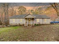 Ranch style home with a covered porch and landscaped yard at 370 Lakestone Estates Ests, Pittsboro, NC 27312