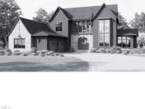 Two-story farmhouse style home with large windows and attached garage at 982 Shelley Rd, Raleigh, NC 27609