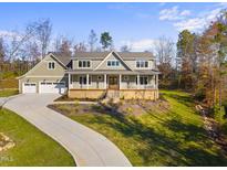 Two-story craftsman style home with a large front porch and three car garage at 154 Leatherwood Ln, Chapel Hill, NC 27517