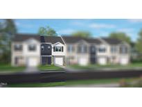 Two-story townhome with gray siding, white trim, and a two-car garage at 19 Sweet Meadow Rd, Angier, NC 27501