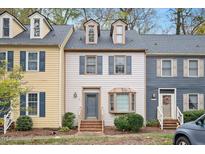 Two-story townhome with gray door and bay window at 3116 Coachmans Way, Durham, NC 27705