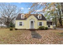 Charming yellow house with a spacious yard and mature trees at 345 Henderson St, Oxford, NC 27565