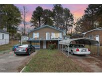 Brick house with carport and balcony, offering curb appeal at 511 Elmira Ave, Durham, NC 27707