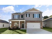 Two-story house with gray siding, brick accents, and a two-car garage at 2010 Fletchers Ridge Dr, Durham, NC 27703