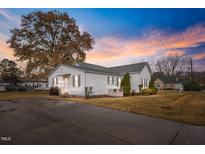 White house with a spacious yard and driveway at 308 E First St, Princeton, NC 27569