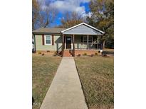 Charming single-story home with covered front porch and landscaped yard at 409 Granville St, Oxford, NC 27565