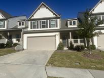 Two-story home with a two-car garage and landscaped lawn at 107 Explorer Dr, Morrisville, NC 27560