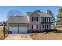 Two-story house with two-car garage and landscaped yard at 360 Sandy Ridge Rd, Dunn, NC 28334