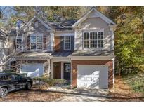 Brick front two-story townhome with two-car garage and landscaping at 4200 Camden Woods Ct, Raleigh, NC 27612