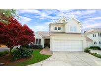 Two-story house with white exterior, brick walkway, and attached garage at 739 Crabtree Crossing Pkwy, Cary, NC 27513