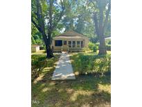 Ranch style home with walkway and mature trees at 114 Barnhill St, Durham, NC 27707