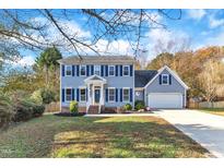 Two-story house with gray siding, a white door, and a two-car garage at 1706 Lisburn Ct, Garner, NC 27529