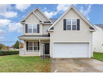 Two-story house with beige siding, a white garage door, and a well-maintained lawn at 2124 Star Sapphire Dr, Raleigh, NC 27610