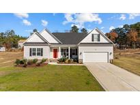 Newly built home with a red front door, two-car garage, and landscaped yard at 80 Black Oak Pl, Spring Lake, NC 28390