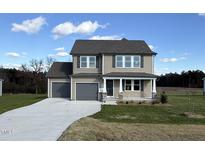 Two-story house with gray siding, gray double garage doors, and a stone accent at 36 Holly Grove Ln, Lillington, NC 27546