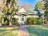 Charming house with brick walkway, mature trees, and well-maintained landscaping at 504 Summitt Dr, Sanford, NC 27330