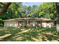 Brick ranch house with attached garage and spacious lawn at 101 Jeffress Dr, Henderson, NC 27537