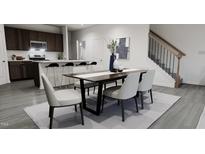 Bright dining area with kitchen and staircase views at 1739 Aspen River Lane, Apex, NC 27502