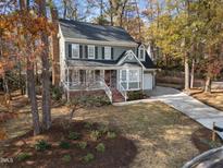 Two-story house with gray siding, brick accents, and a landscaped yard at 203 Parkcanyon Ln, Cary, NC 27519