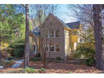 Two-story house with brick and siding, showcasing a charming curb appeal at 101 Songbird Ln, Chapel Hill, NC 27514