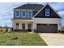 Two-story house with gray and beige siding, a two-car garage, and a landscaped lawn at 1815 Parham Dr, Graham, NC 27253