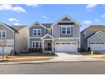 Two-story home with gray siding, white trim, and a two-car garage at 504 Morning Glade St, Wake Forest, NC 27587