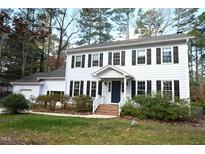 Two-story house with white siding, dark shutters, and a brick walkway at 5012 Knaresborough Rd, Raleigh, NC 27612