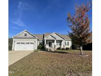 Ranch style home with gray siding, stone accents, and a two-car garage at 115 Hunterwood Pl, Benson, NC 27504