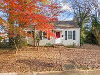 Charming single-story house with a red door and autumn leaves at 307 Bickett Blvd, Raleigh, NC 27608